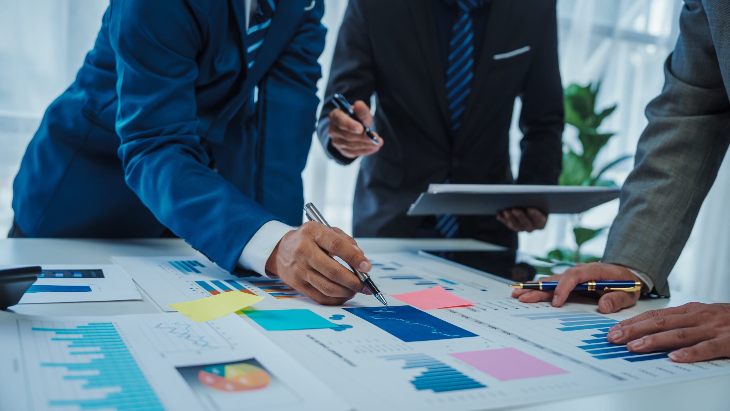 Business team analyzing financial reports and data charts during a meeting.